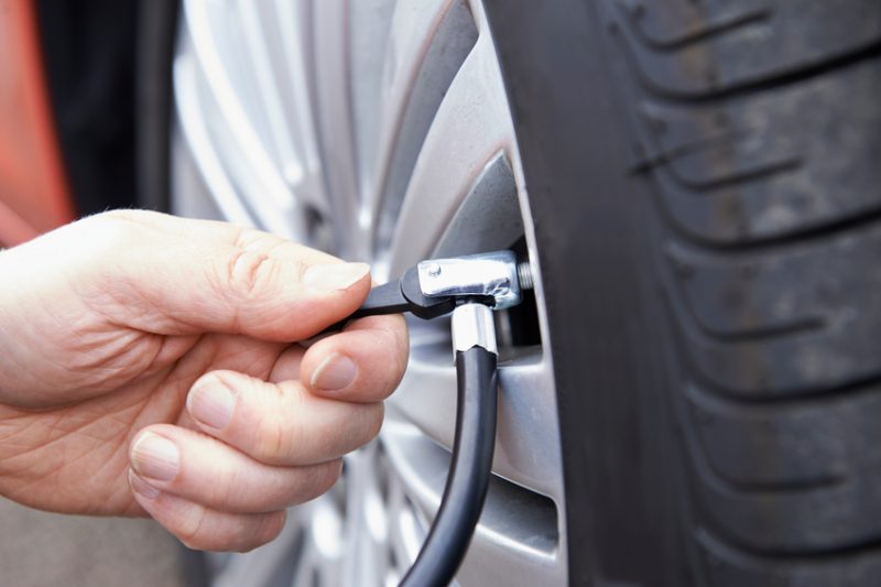 Close Up Of Man Inflating Car Tyre