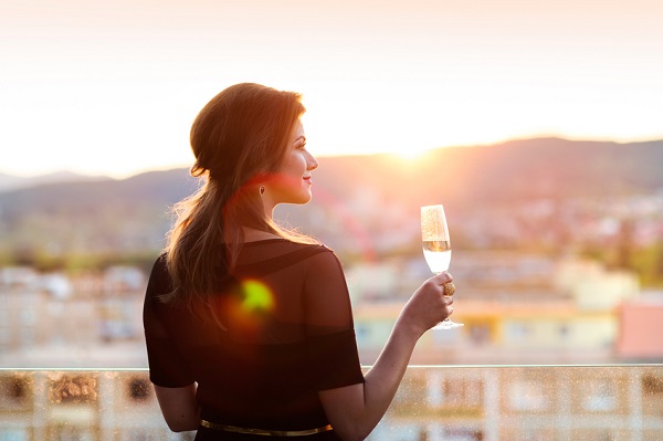 Attractive young woman with a drink on a terrace of a bar