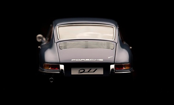 Beaconsfield, UK - February 22, 2016: A 1:18 scale model of a 1964 Porsche 911 made by Auto Art, set against a solid black background. Low key image of the back end of the car.